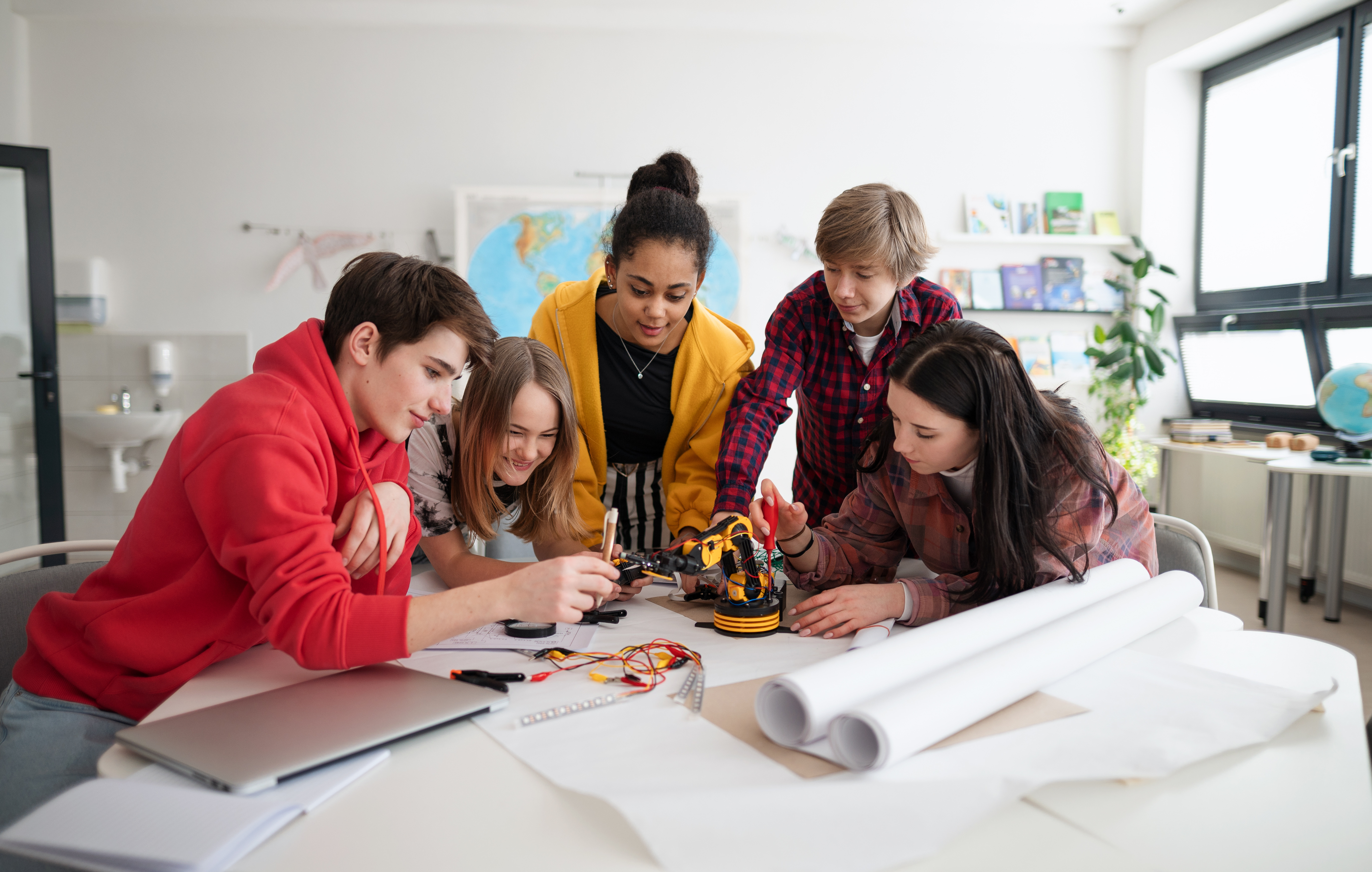 A group of students work on a project in the classroom.